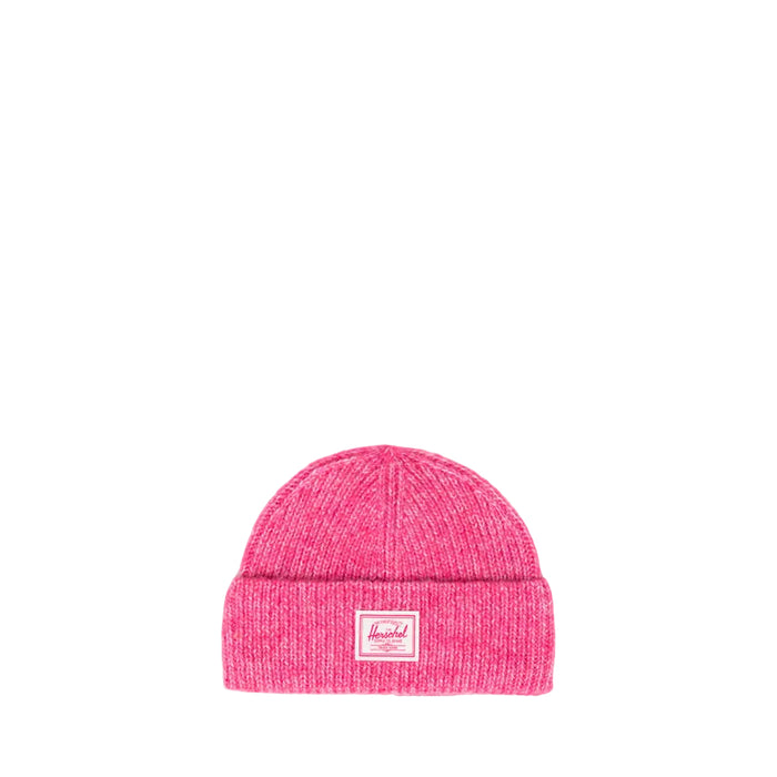 A bright pink knit beanie hat with a folded cuff and a small rectangular Herschel logo patch on the front, photographed against a white background.