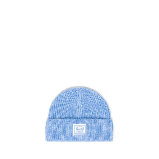 Blue knit beanie with a Herschel brand label on a white background