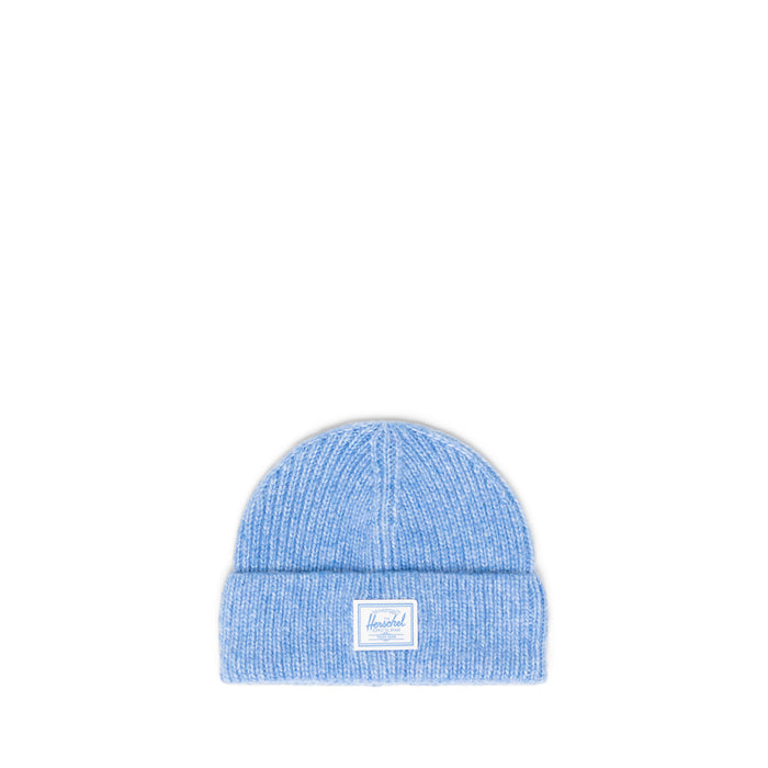 Blue knit beanie with a Herschel brand label on a white background