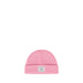 A pink knit beanie hat with a folded cuff and a small white Herschel logo patch in the center on a white background.
