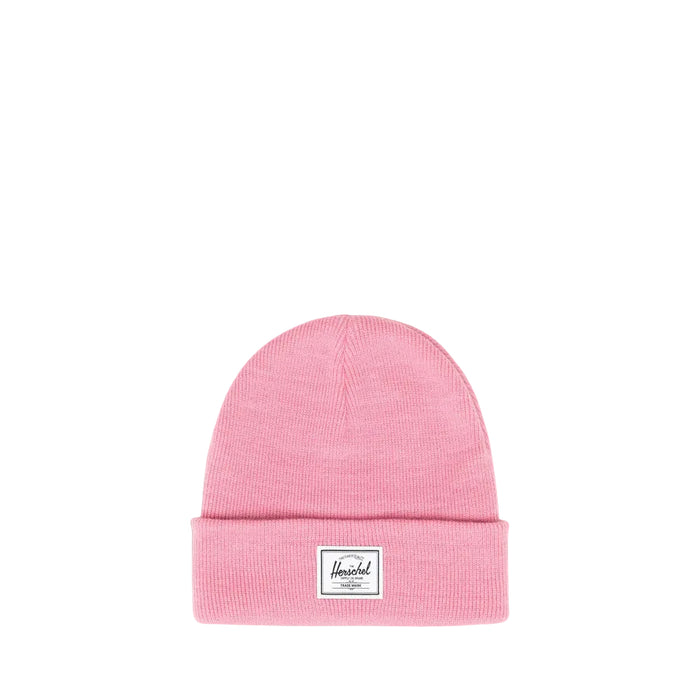 A pink knit beanie hat with a folded cuff and a small white Herschel brand patch on the front against a white background