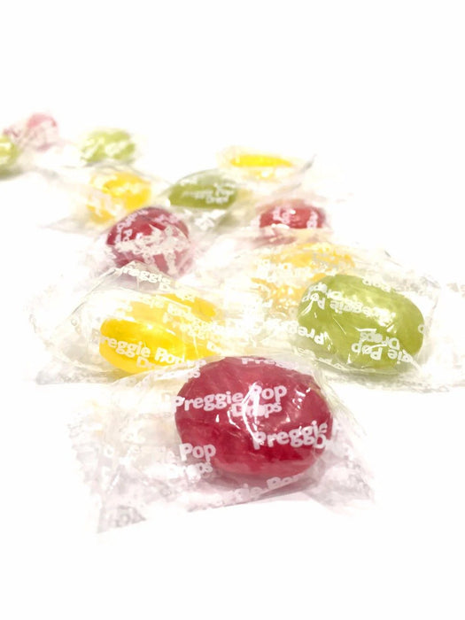 Colorful Preggie Pop candies in clear wrappers on a white background