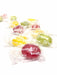 Colorful Preggie Pop candies in clear wrappers on a white background