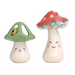 Two mushroom-shaped shaker toys with smiling faces on a white background