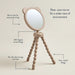 Rear-view stroller mirror with a 360-degree swivel design on a beige background