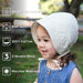 Child wearing a white sun hat with text highlighting features like 50+ UPF sun protection, baby safety, 100% cotton, 3-season wear, and machine washability.