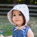 Child wearing a floral sun hat outdoors