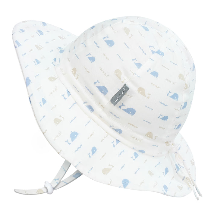 Two baby sun hats with whale pattern on a white background