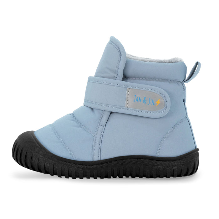 Light blue children's boot with black sole on a white background