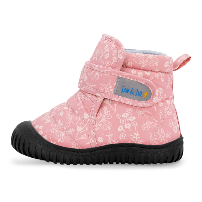 Pink children's boot with floral pattern and black sole on a white background