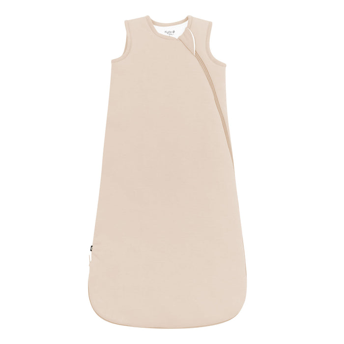 Soft beige baby sleeping bag on a white background