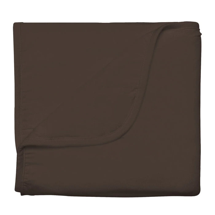 Folded brown baby blanket on a white background