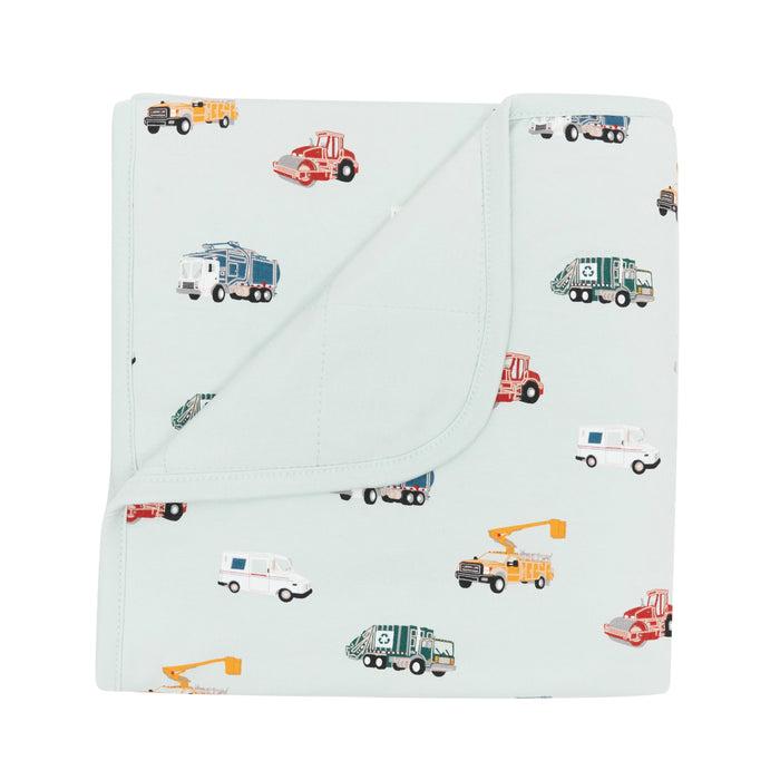 Folded blanket with vehicle pattern on a white background