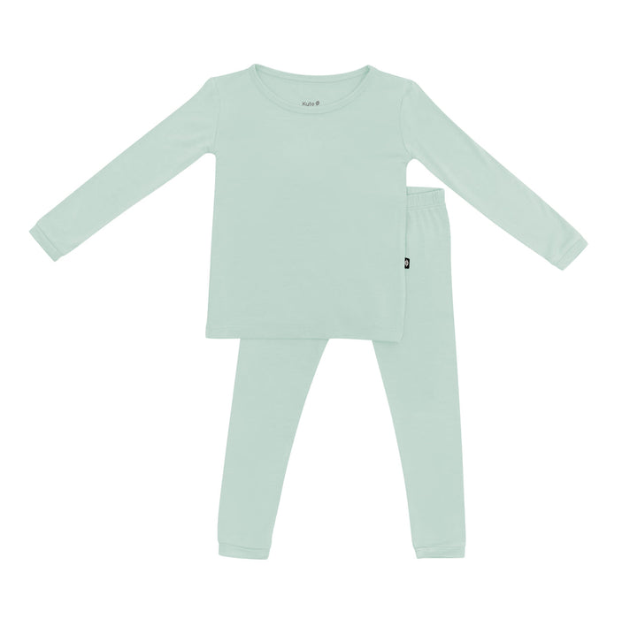 Green children's pajama set on a white background