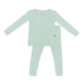 Green children's pajama set on a white background