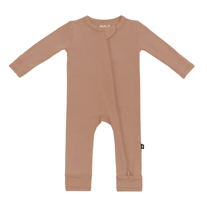 A zippered brown Kyte Baby romper for babies on a white background