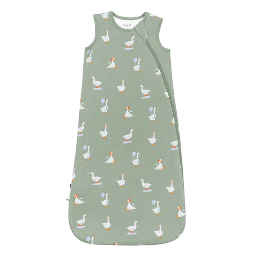 Green baby sleeping bag with duck pattern on a white background