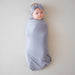 caption-Baby in haze purple swaddling blanket and matching bow (sold separately)