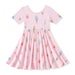 Pink dress with ice cream cone pattern on a white background