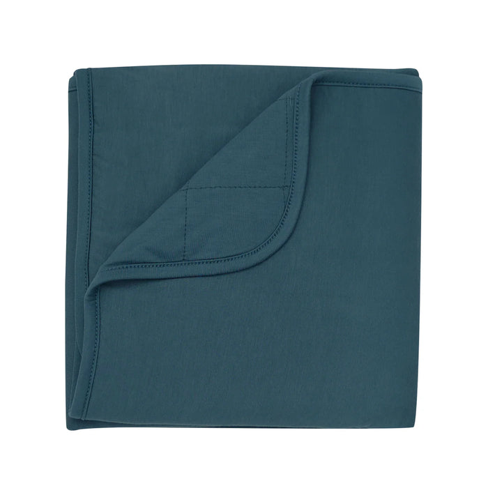 Teal blue baby blanket folded neatly on a white background