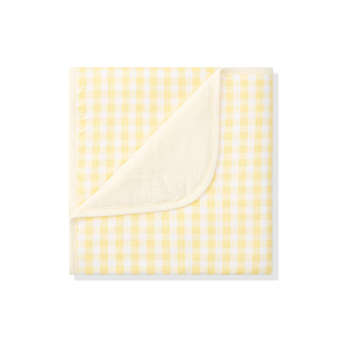 Yellow and white checkered blanket on a white background