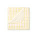 Yellow and white checkered blanket on a white background