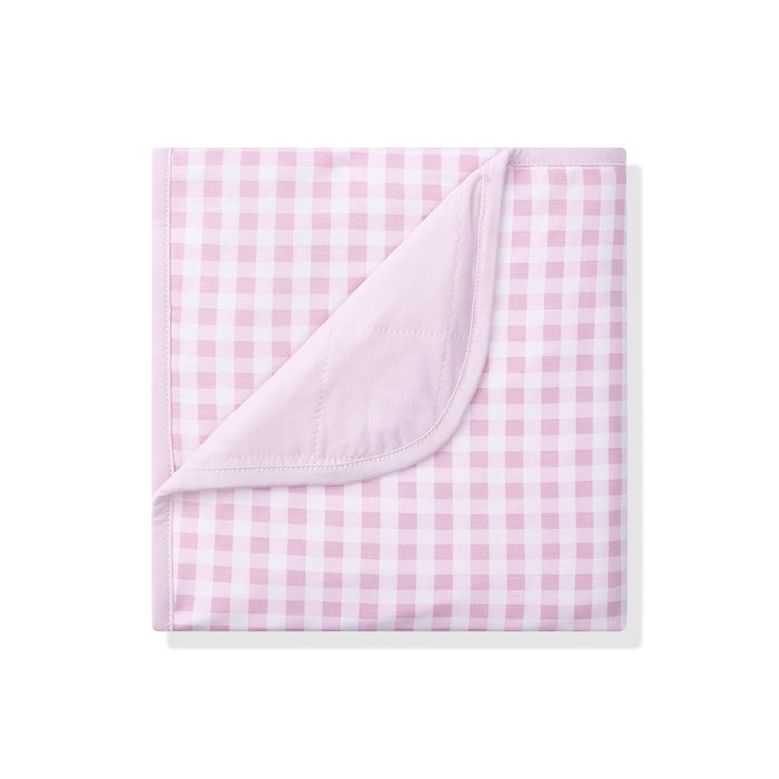Pink and white checkered blanket on a white background