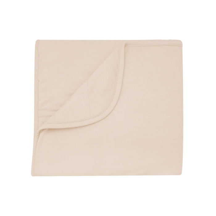 Beige Baby blanket folded on a white background