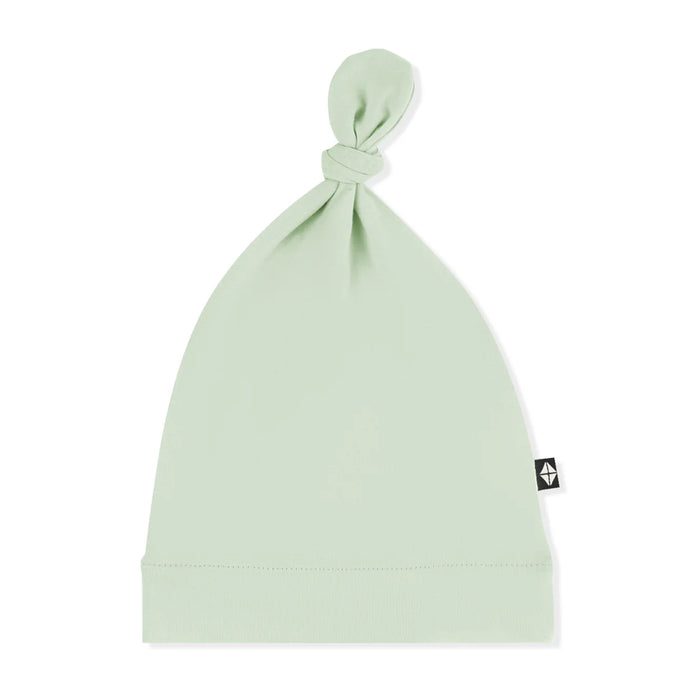 Light green baby hat with a knot on top against a white background