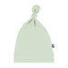 Light green baby hat with a knot on top against a white background