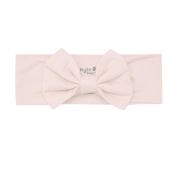 Pink headband with a bow on a white background