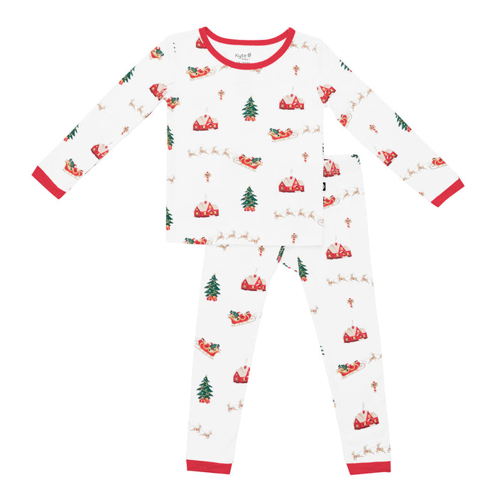 Kyte Children's pajama set with Christmas tree and reindeer pattern on a white background