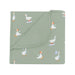 Folded green blanket with goose pattern on a white background