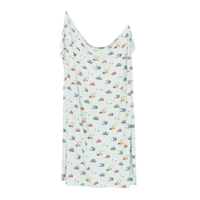 Light blue slip dress with colorful car pattern on a white background