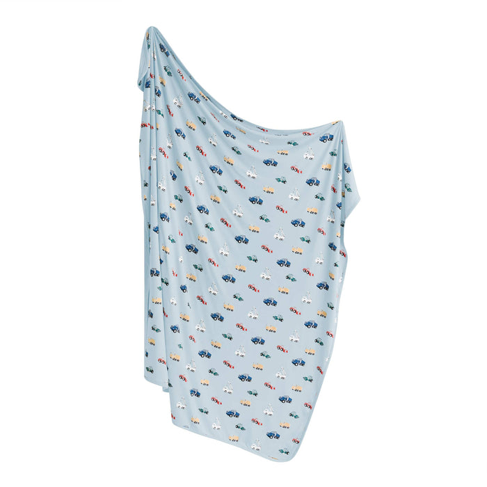 Light blue blanket with construction pattern on a white background