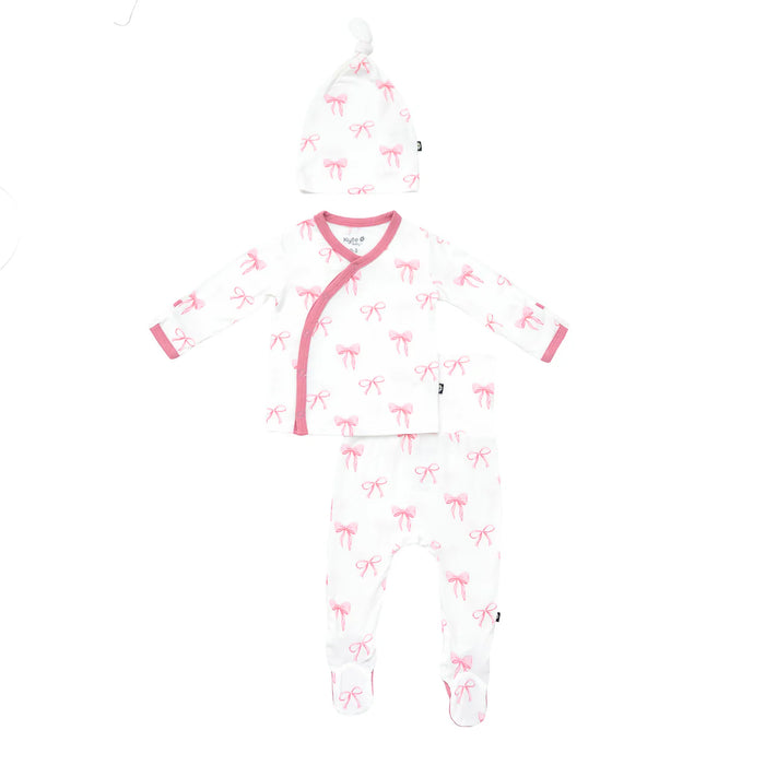 White baby newborn set in bamboo with pink bow pattern on a white background