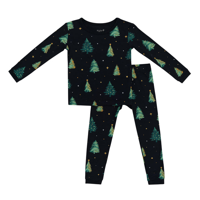 Kyte Children's pajama set with tree pattern on a black background