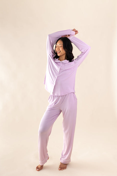 Woman wearing a thistle purple pajama set against a beige background