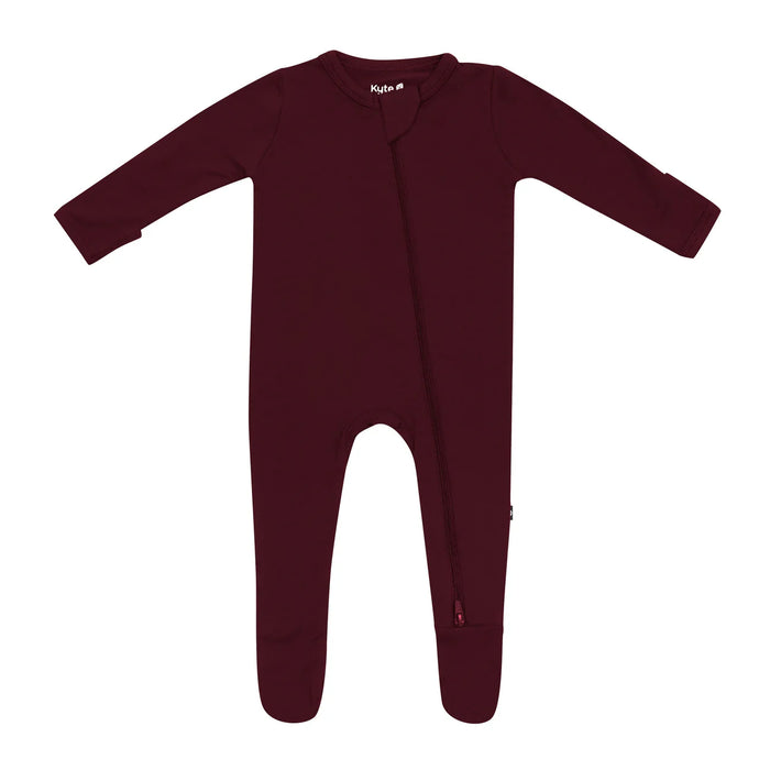 Burgundy baby footed sleeper on a white background