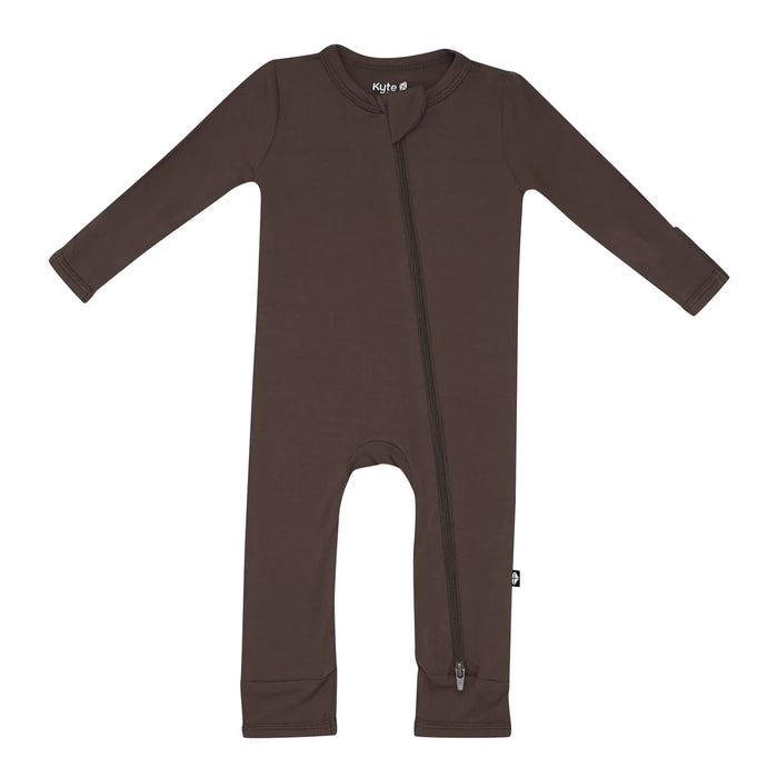 A zippered brown Kyte Baby romper for babies on a white background