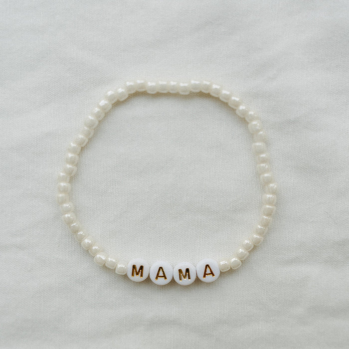 Ivory glass beaded MAMA bracelet against a white background
