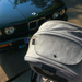 Gray stroller with a BMW car in the background