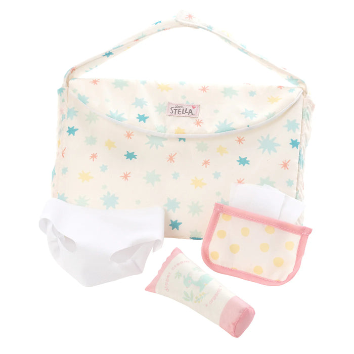 Baby care set with changing pad, diaper, and wipes on a white background