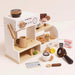 Wooden toy coffee set with various items on a white background