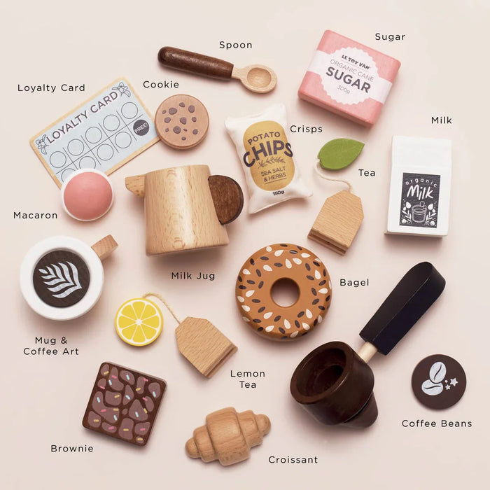 Collection of toy food items and accessories on a light background with labels.