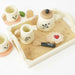 Children's tea set with cups, teapot, and cookies on a tray