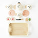 Children's tea set with teapot, cups, and cookies on a white background