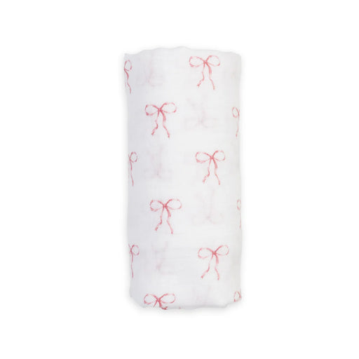 White fabric swaddle with pink bow pattern on a white background