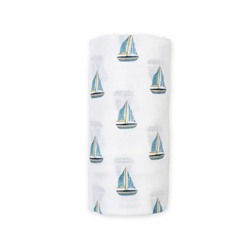 Rolled cotton swaddle baby blanket with sailboat pattern on a white background