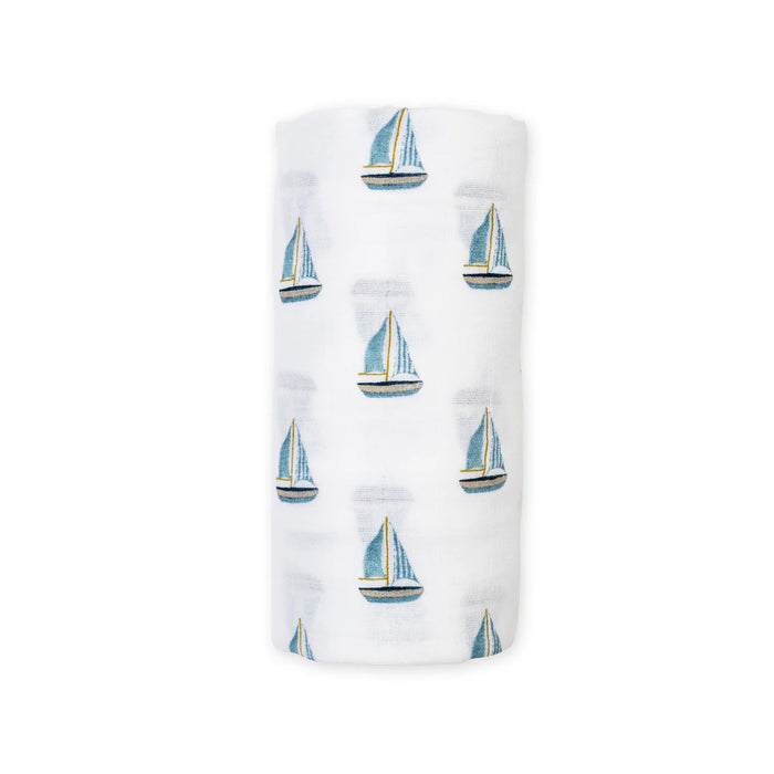 Rolled cotton swaddle baby blanket with sailboat pattern on a white background